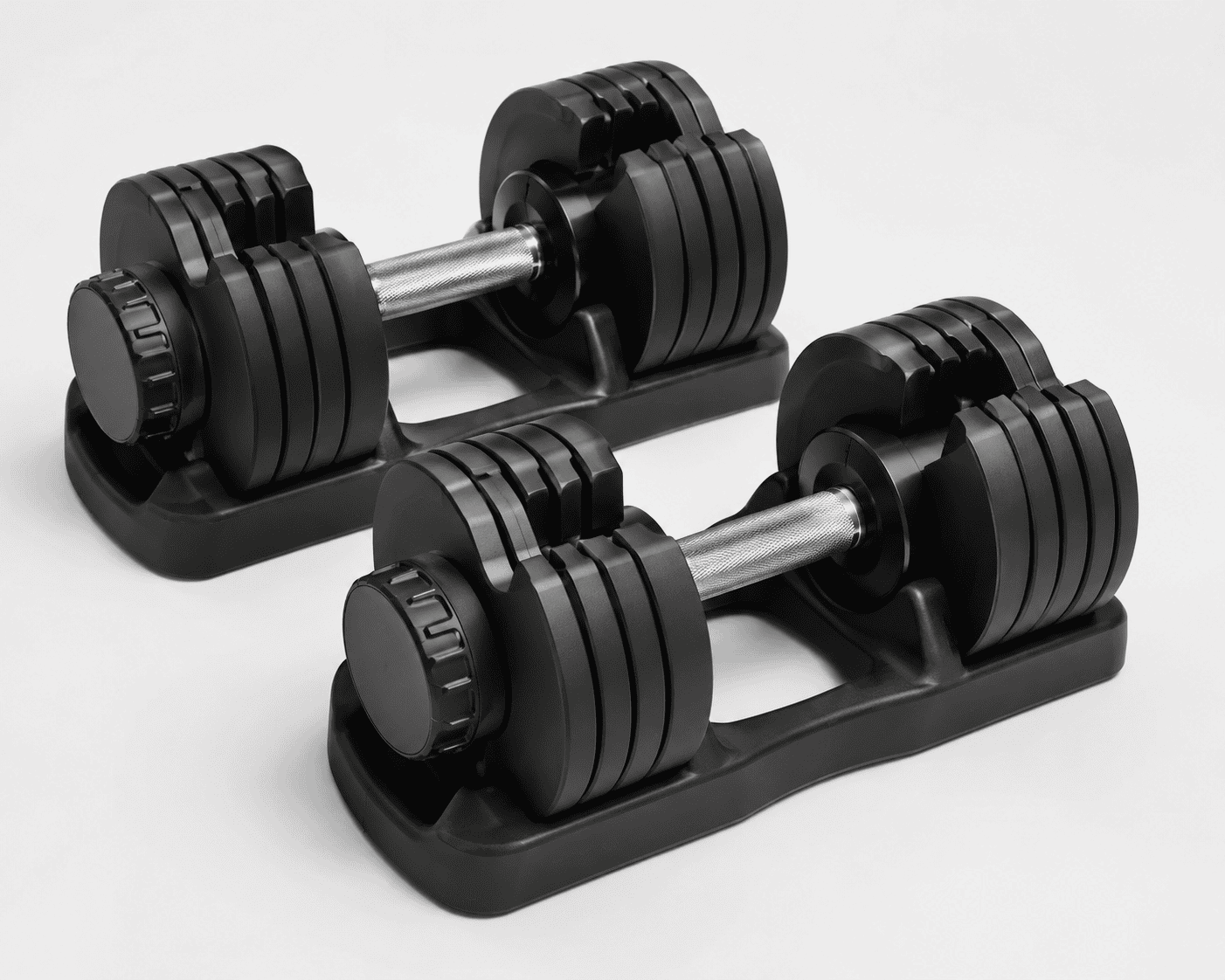 Pair of dial selector adjustable black dumbbells with metal handles on a white background.