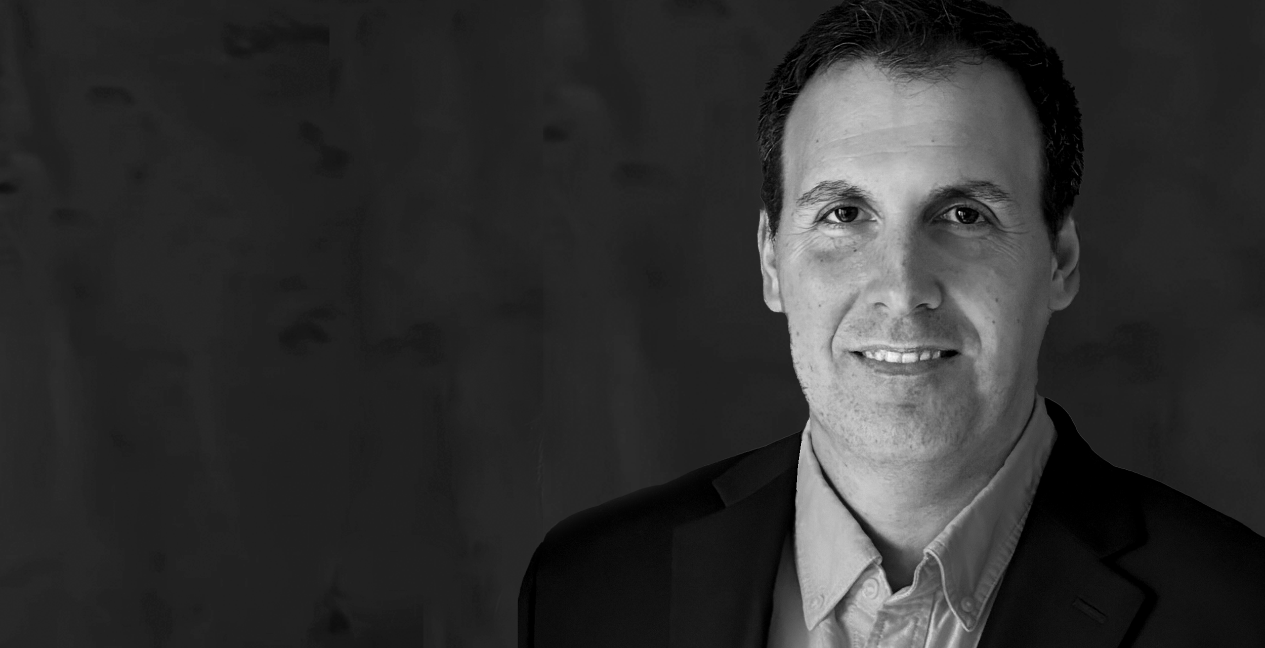 A black and white portrait of Jonathan Pace, New Account Director at DEY.