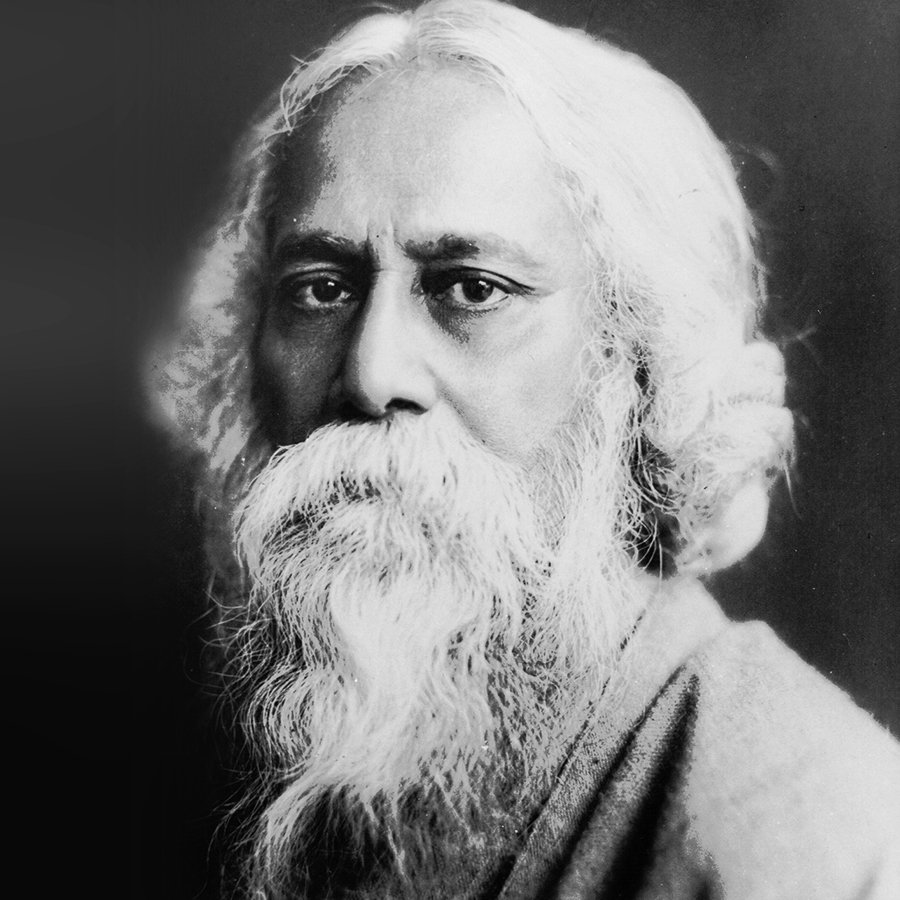 Black and white portrait of an elderly man with long white hair and a full white beard, looking directly at the camera.