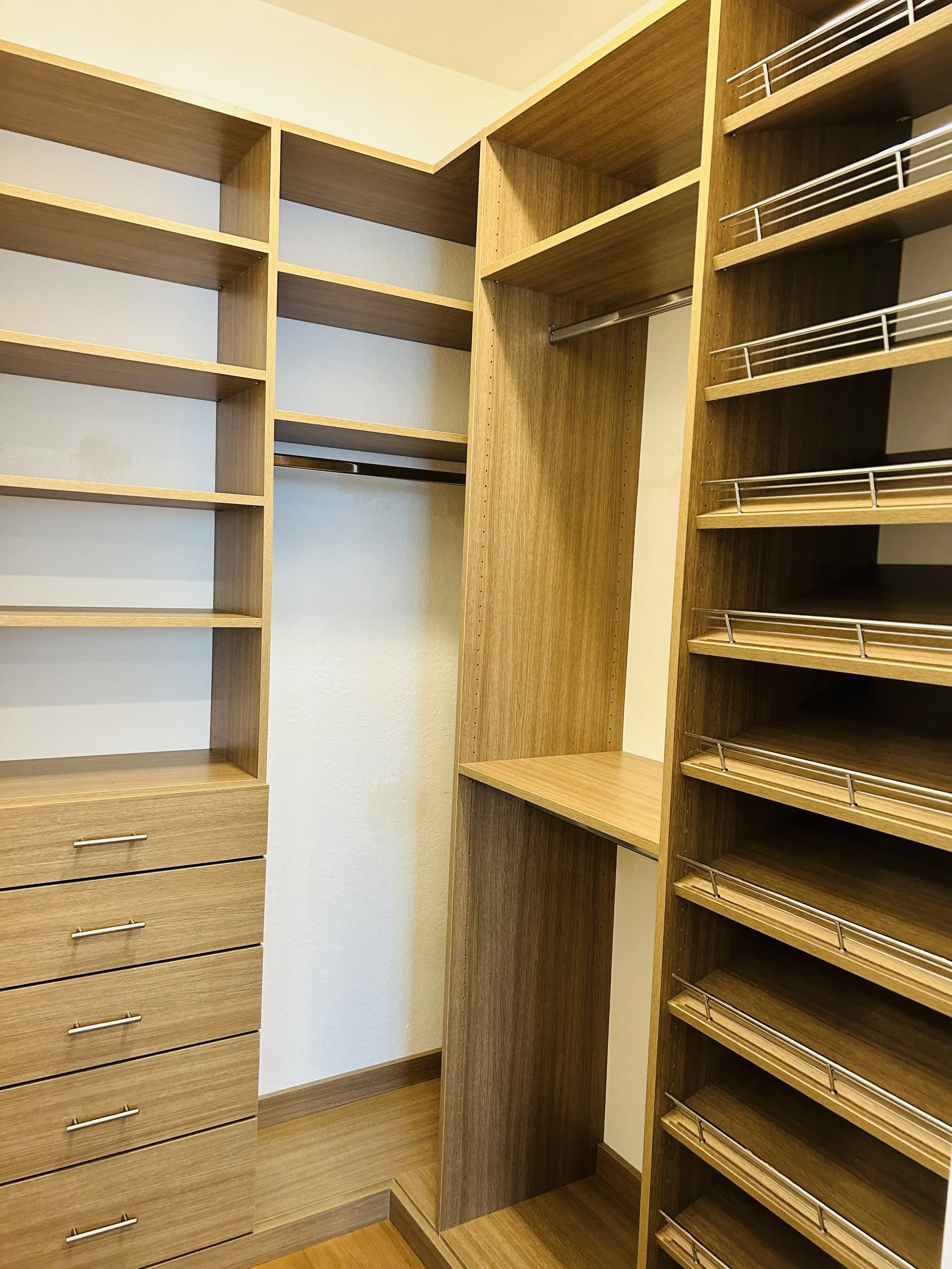 Custom Daytona walk-in closet shelving and hanging storage with textured Egger finish.