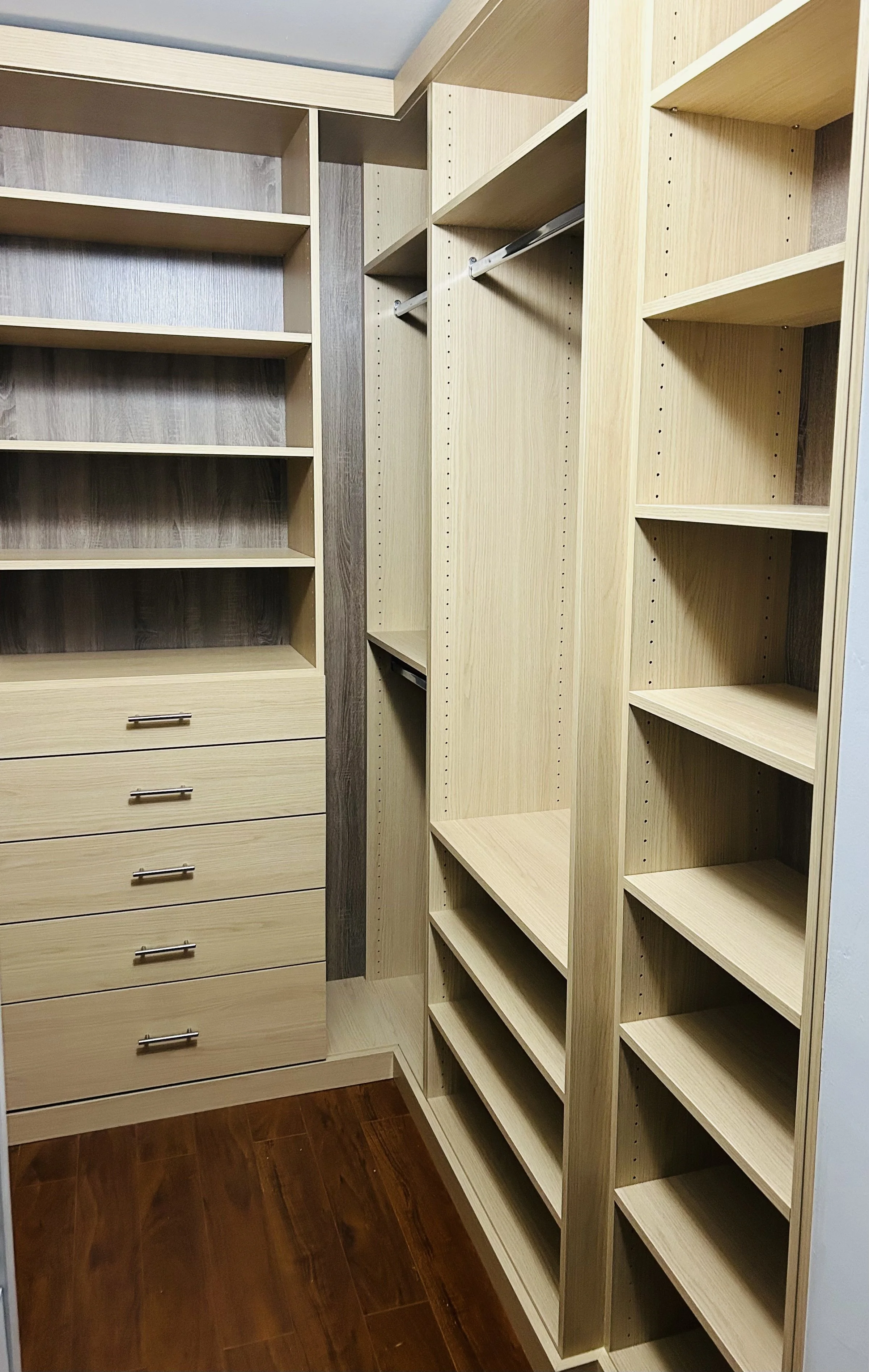 Custom Sarasota Upgraded walk-in closet shelving and drawer system with textured Egger panels.