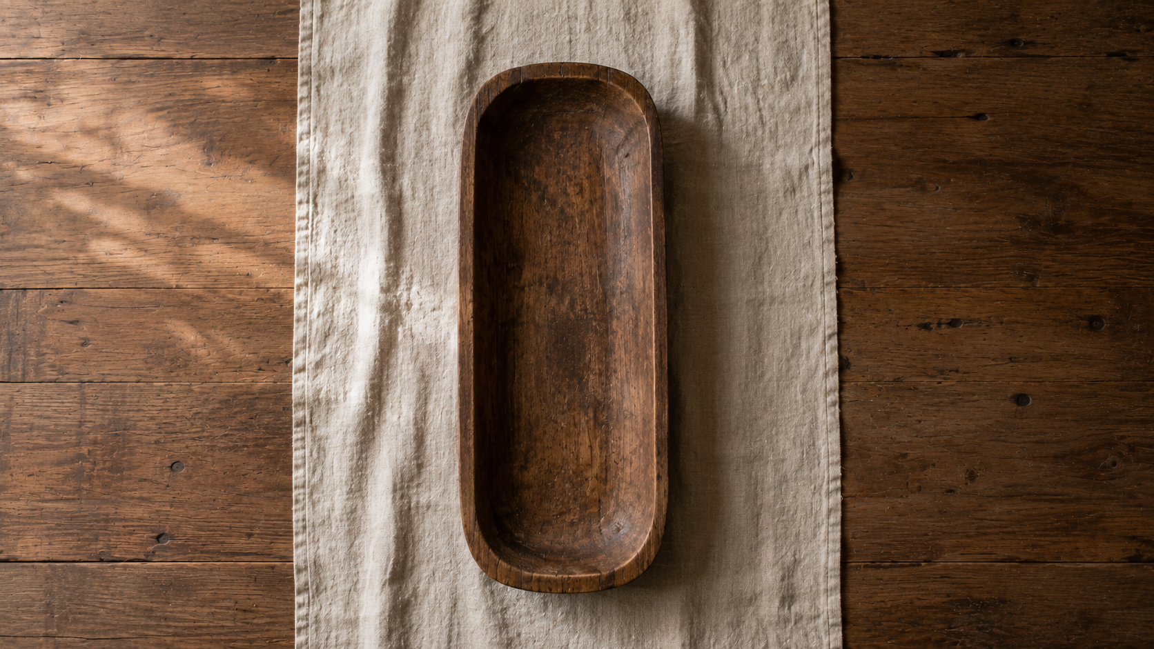 Step 1 of a harvest centerpiece begins with a natural flax linen runner and weathered wooden tray, creating a calm foundation for timeless autumn table styling.