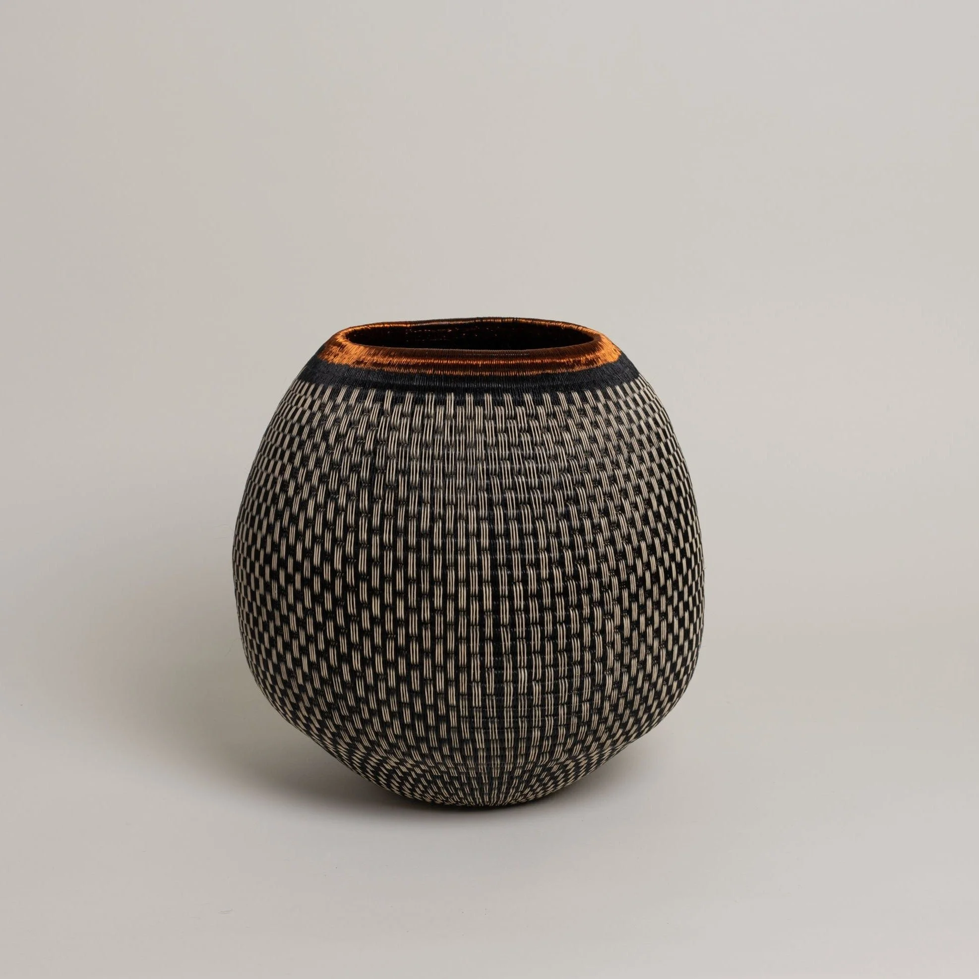 Hand-woven werregue fibre vessel with a copper rim, made by Colombian artisans