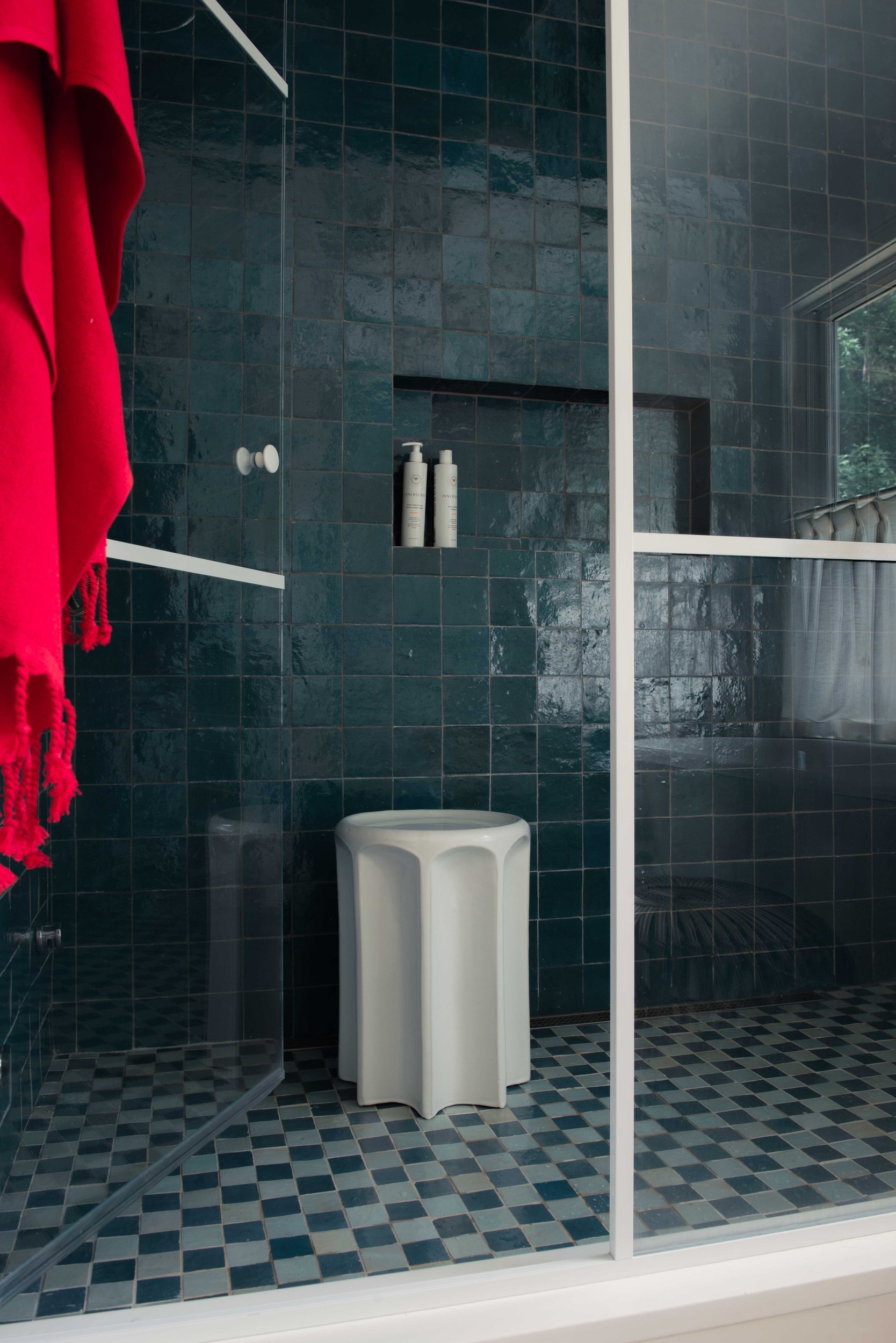 Silvernails shower with deep green zellige tile, a patterned floor and steel-framed glass