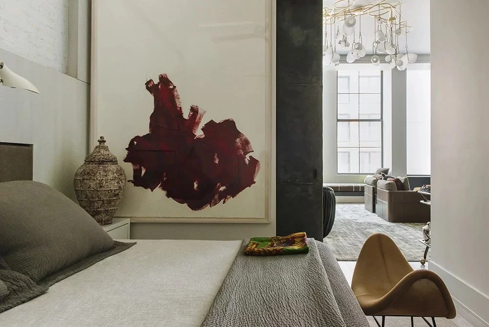 Bond St living room with a large red botanical artwork, low sofa and sculptural chandelier