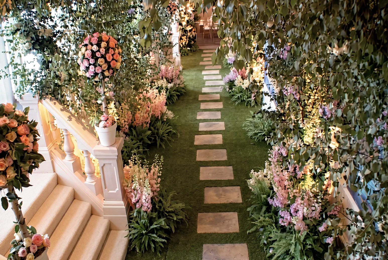 Four Seasons Luxury wedding transforming guest entry area to ceremony to a fairytale inspired indoor garden
