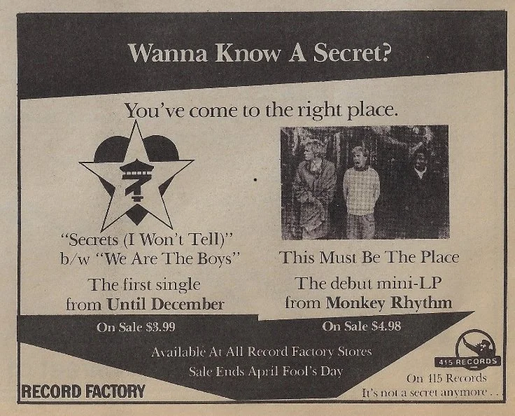 An advertisement for Record Factory featuring two music releases. The first is a single titled "Secrets (I Won't Tell)" by The Boys, priced at $3.99. The second is a mini-LP titled "This Must Be The Place" by Monkey Rhythm, priced at $4.98. The sale 