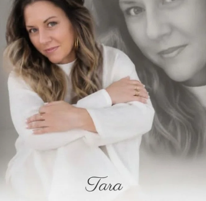 A woman with wavy brown hair sitting with arms crossed, wearing a white long-sleeve top, and smiling at the camera. Behind her, there is a large, semi-transparent black-and-white portrait of her face. The name "Tara" is written at the bottom in cursive.