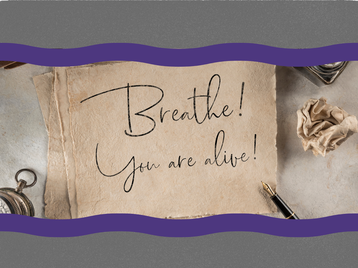 A handwritten note on a torn piece of paper with the message "Breathe! You are alive!" surrounded by an ink bottle, crumpled paper, and a fountain pen.