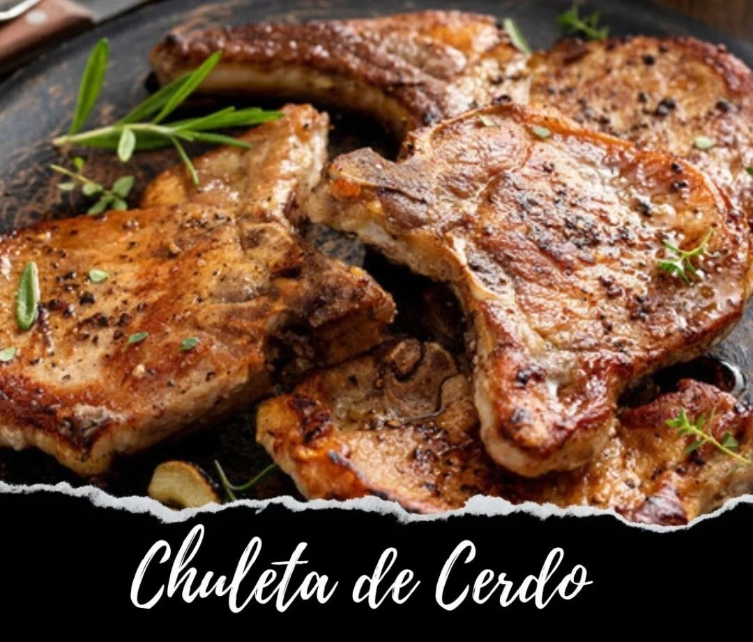 Close-up of grilled pork chops garnished with fresh herbs, served on a dark plate.
