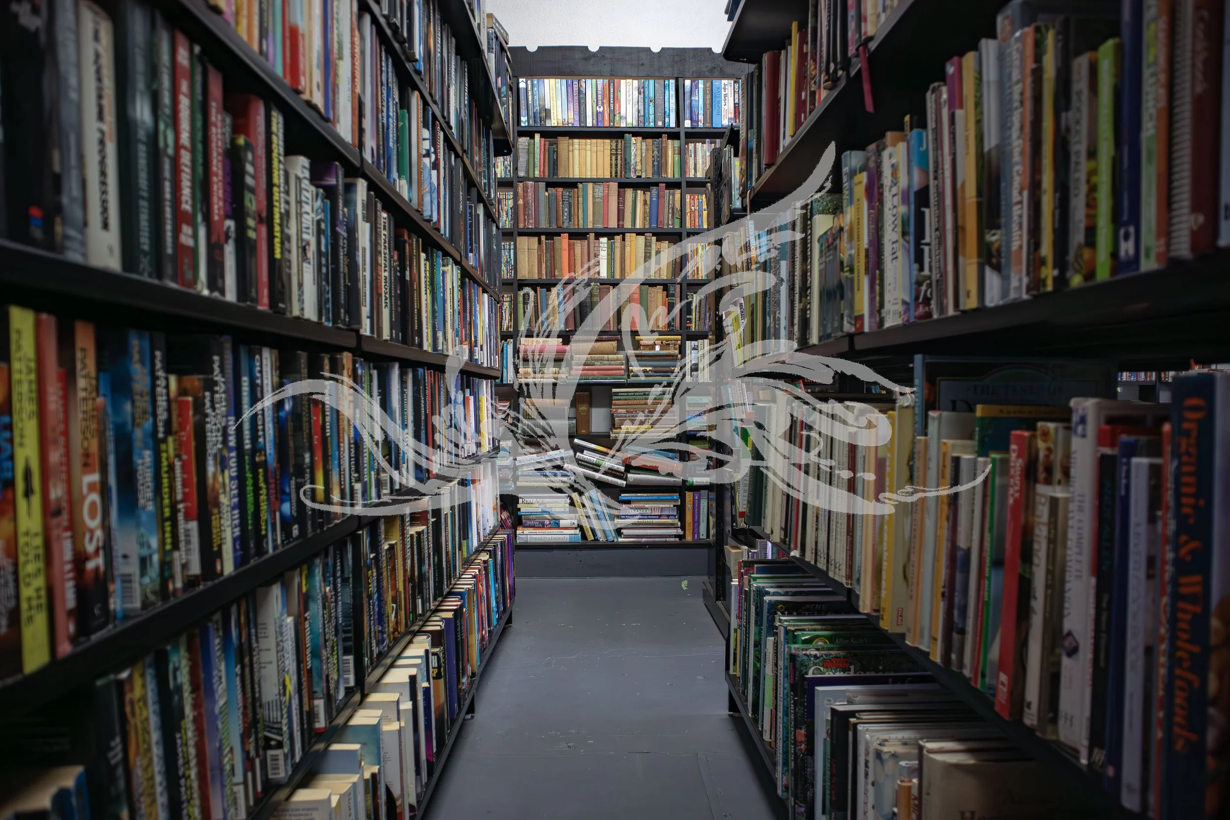 Bookshelves filled with books in a library aisle, viewed from the ground level looking straight ahead.