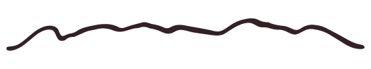A silhouette of a mountain range under a cloudy sky.
