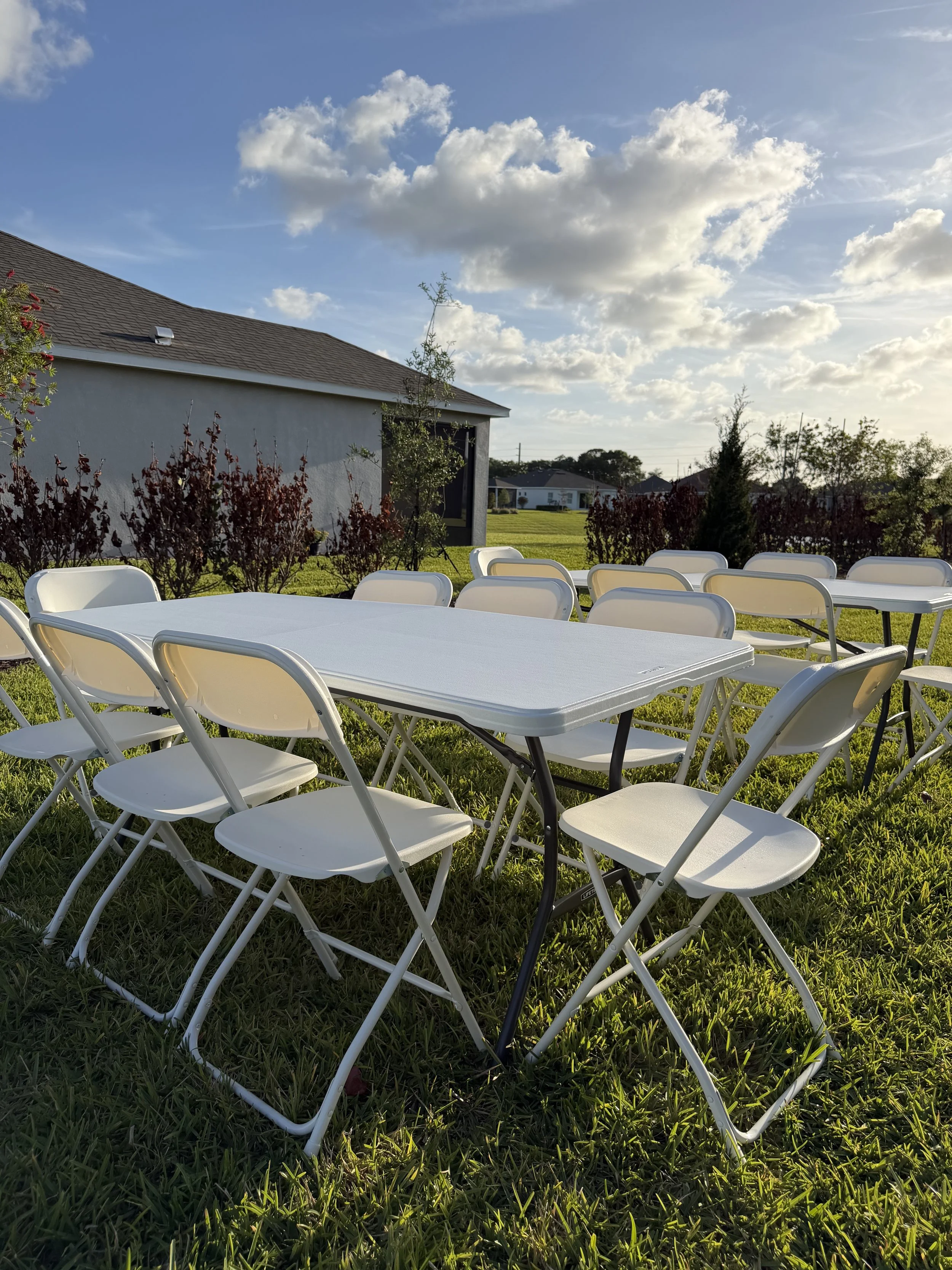 Commercial-grade white folding chairs for rent — 350 lb weight capacity, indoor and outdoor use, any quantity available, Saltwater Event Co. Treasure Coast FL