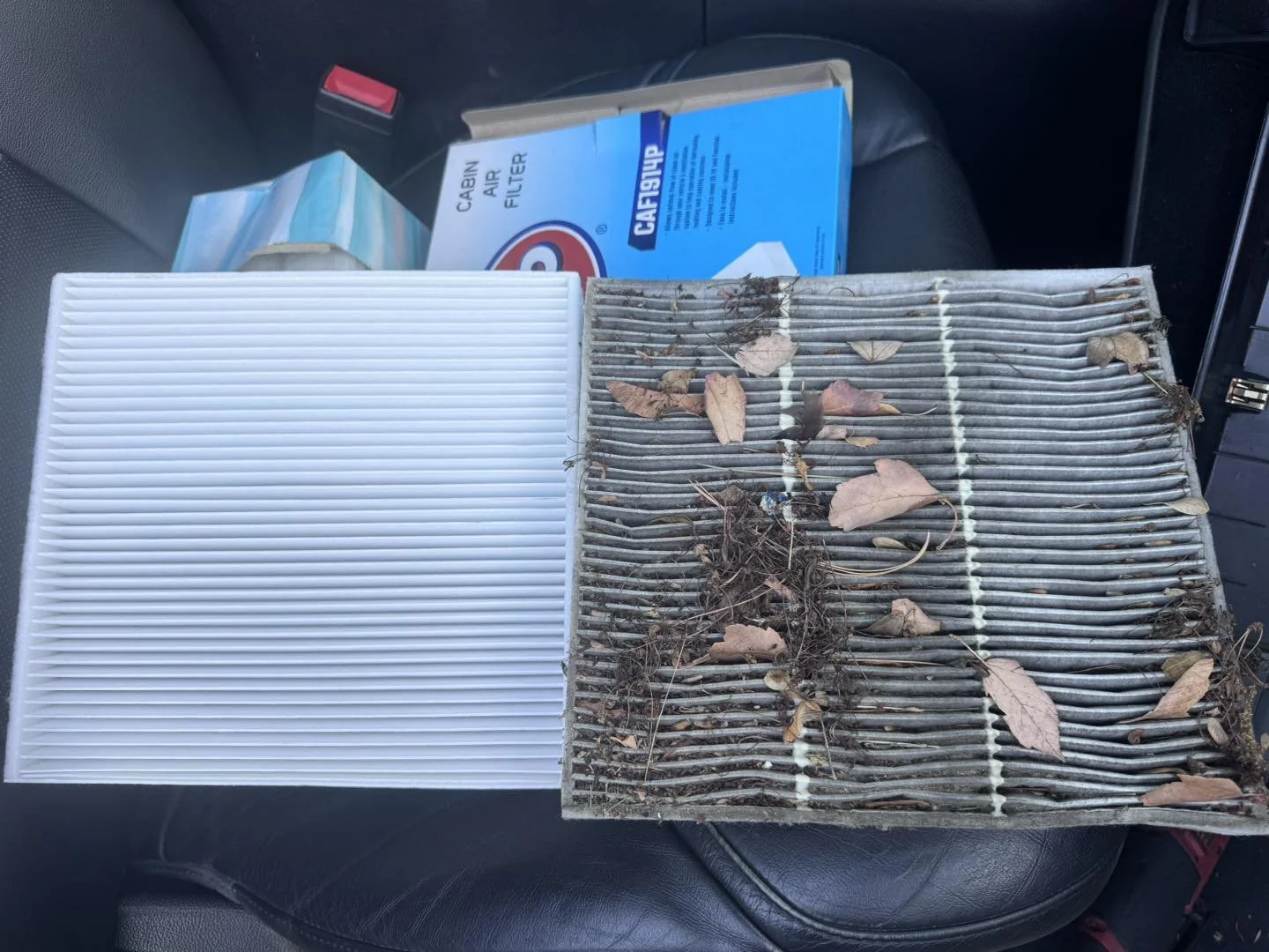 Comparison of a clean car air filter on the left and a dirty, clogged air filter covered in leaves and debris on the right.