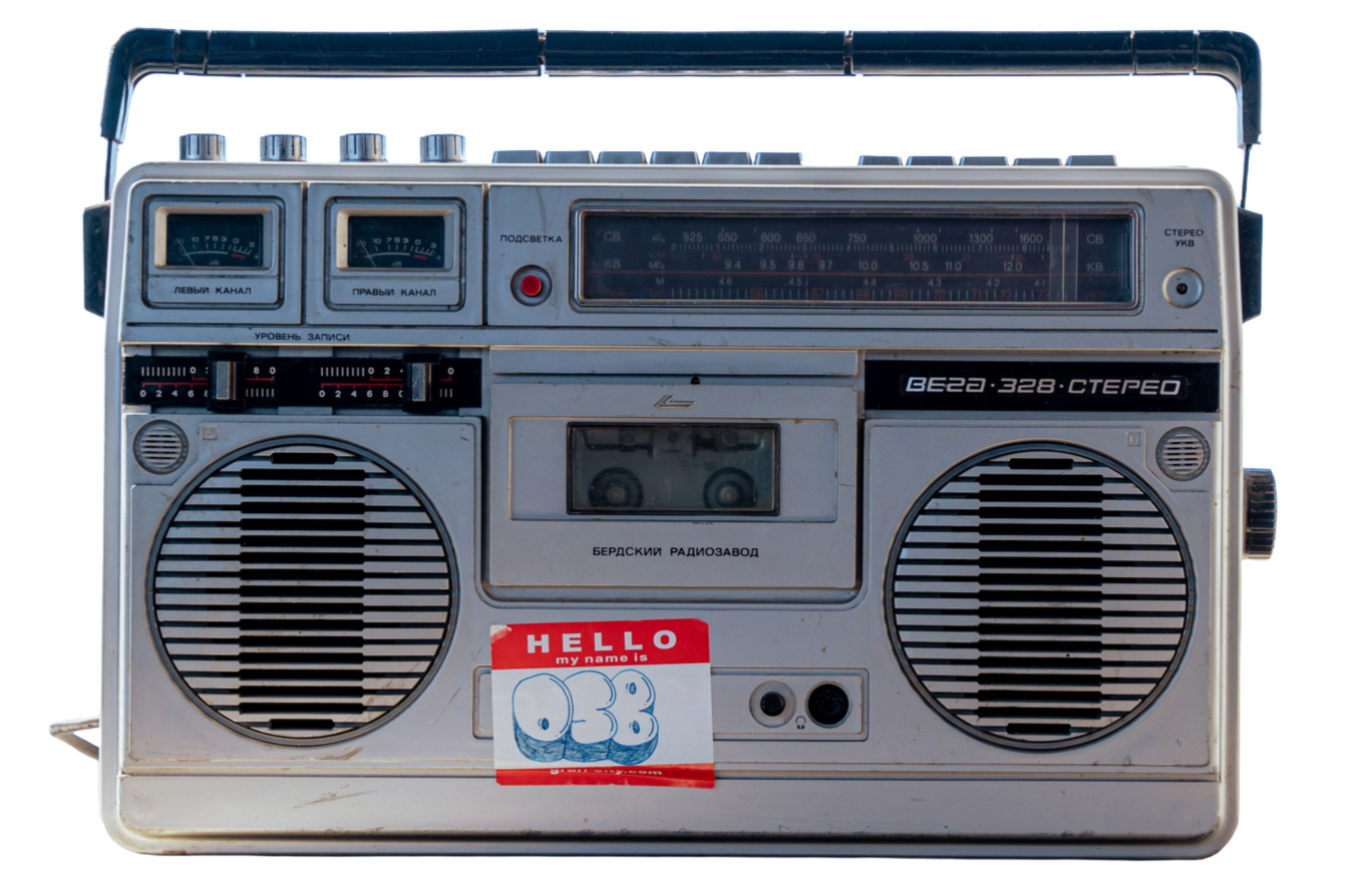 A vintage portable stereo radio boombox with record player, speakers, and radio tuner.