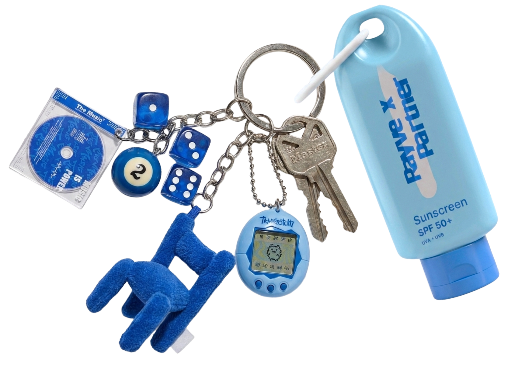 Close-up of a keychain, with a collection of blue charms like dice, keys, a Tamagotchi device, a pool ball, a miniature cd in a case and a blue plush chair, with a blue sunscreen bottle "with Rayve x Partner" on it in a stylized design.