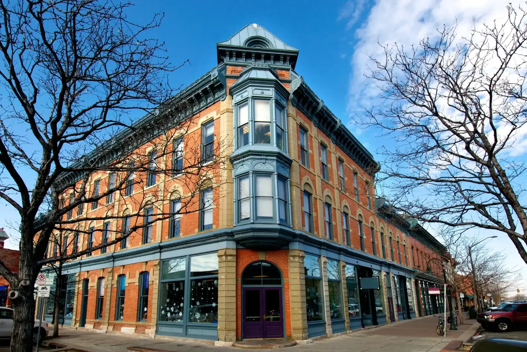 A corner building with red brick and blue trim