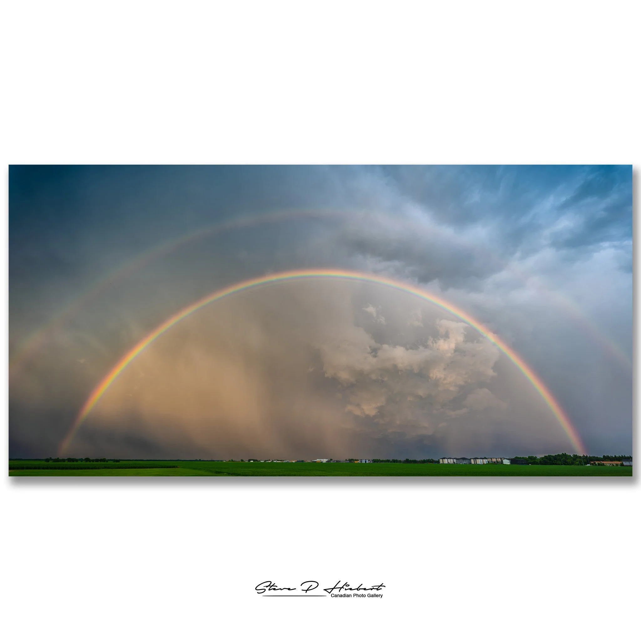 Today's storm wasn't exactly photogenic.

I spent time trying to photograph it, but all I found were dark gray clouds and steady rain. I almost called it a day.

Then, right at the end, the sun broke through and this incredible double rainbow appeare