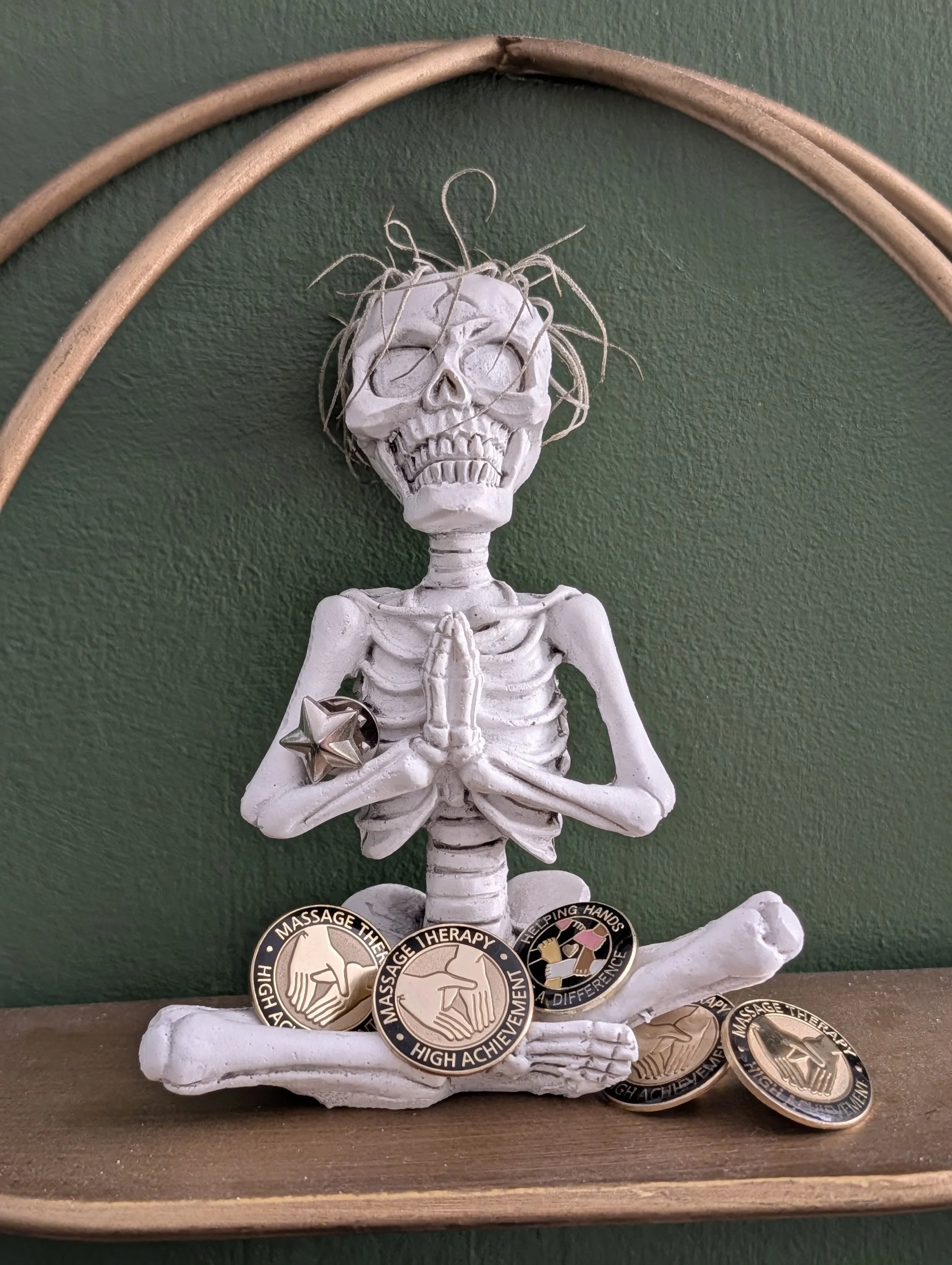 whimsical skeleton holding various pins