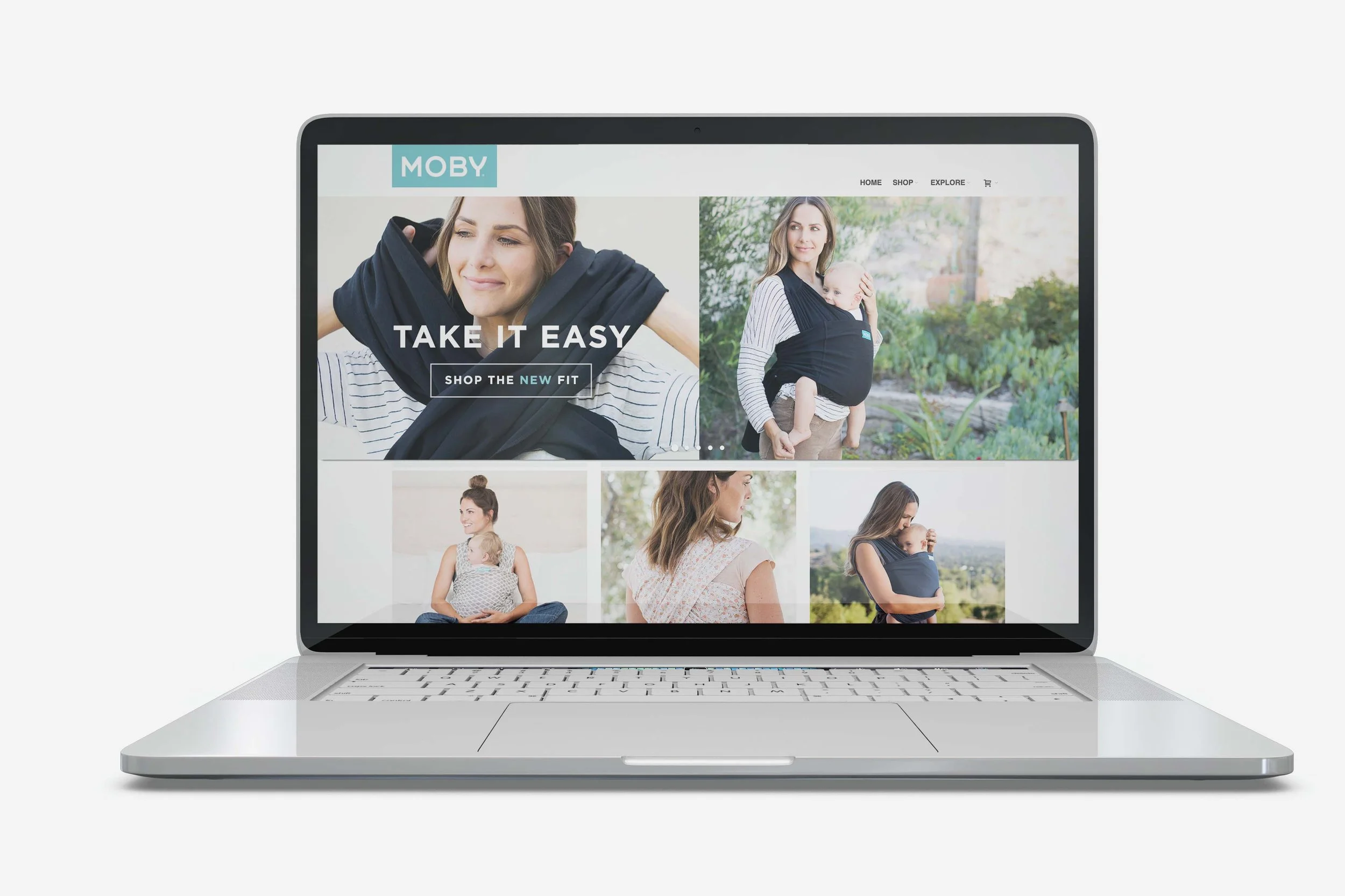 Laptop displaying a website for MOBY with images of women carrying babies and promotional text.