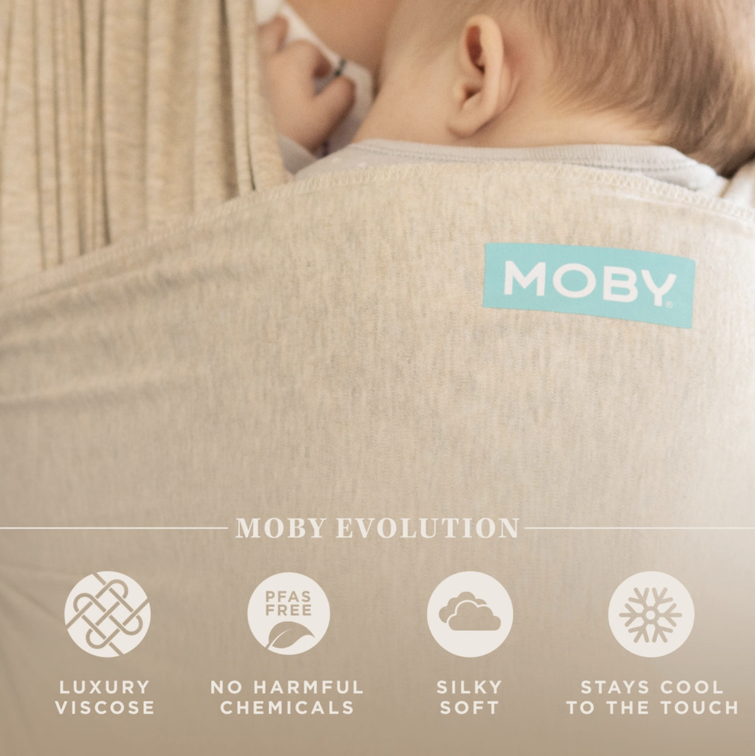 Close-up of a baby sleeping on a person's shoulder, wearing a beige garment with a "MOBY" tag, with icons indicating the product features: luxury viscose, no harmful chemicals, silky soft, stays cool to the touch.