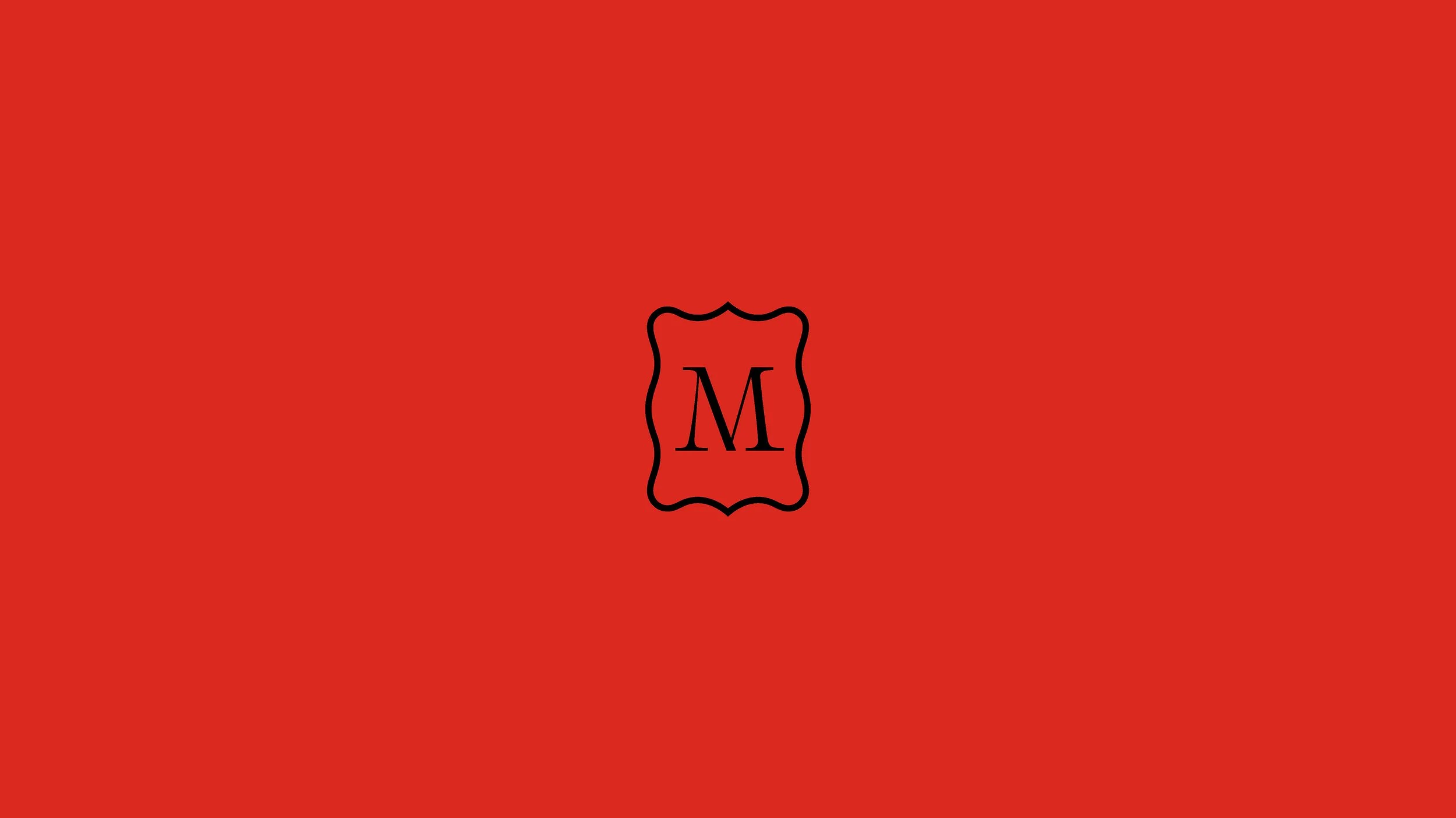 A red background with a black letter 'M' inside a wavy black border in the center.