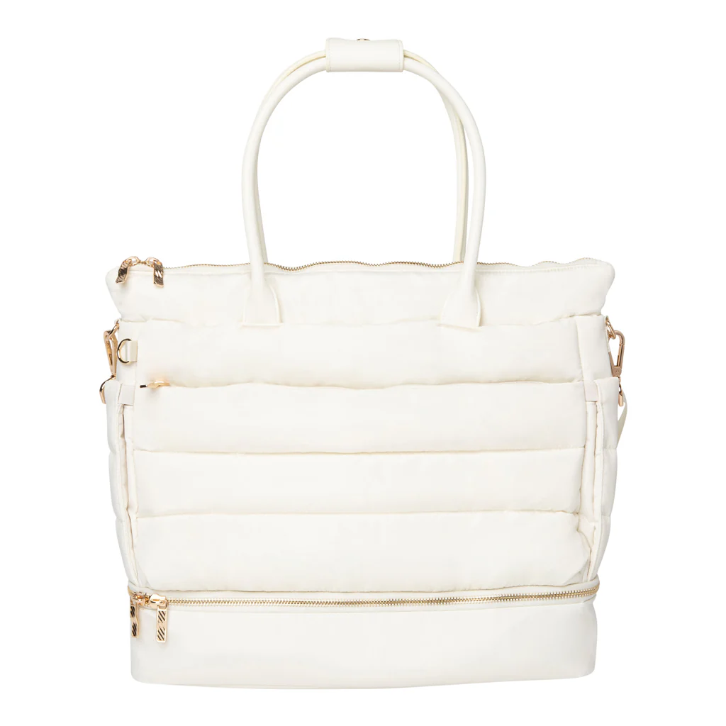 A white quilted handbag with gold zippers and handles, and side clasps.