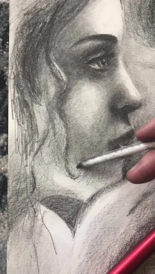 Graphite portrait drawing in progress by Alicia Maye. Woman's profile with detailed shading.
