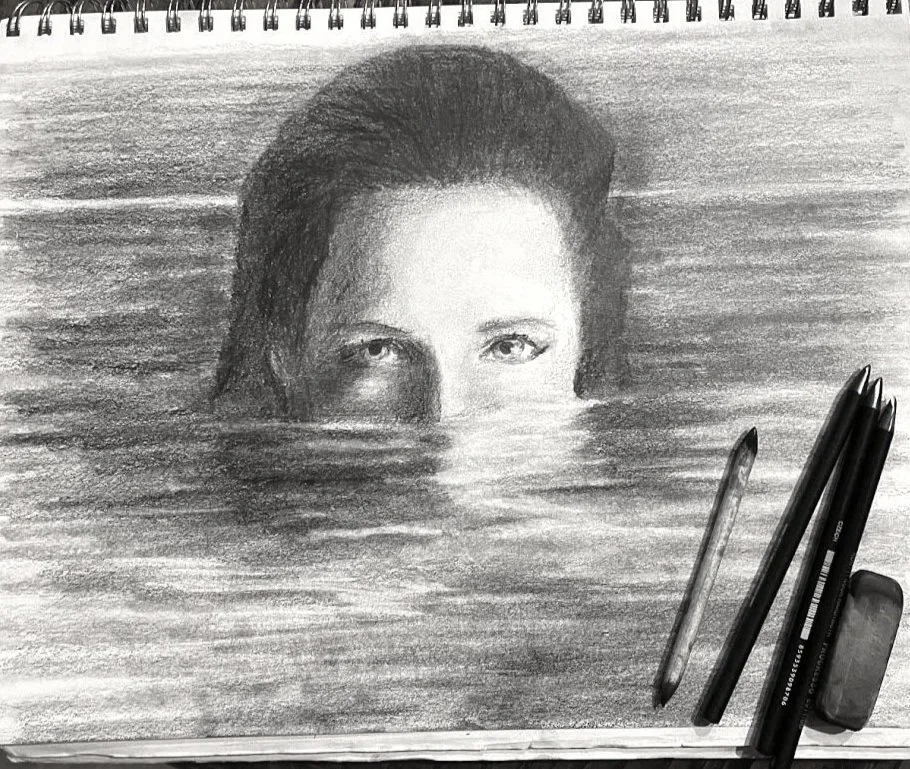 Graphite self portrait drawing by Alicia Maye. Woman partially submerged in water, eyes above waterline.