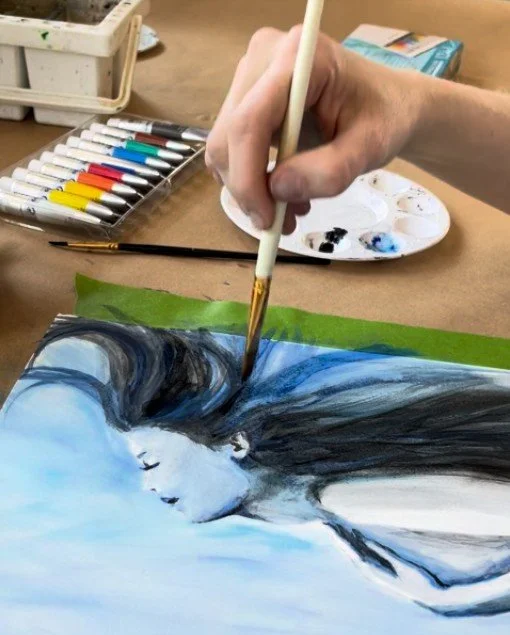 Alicia Maye painting a portrait in watercolor. Woman with closed eyes, vibrant color palette.