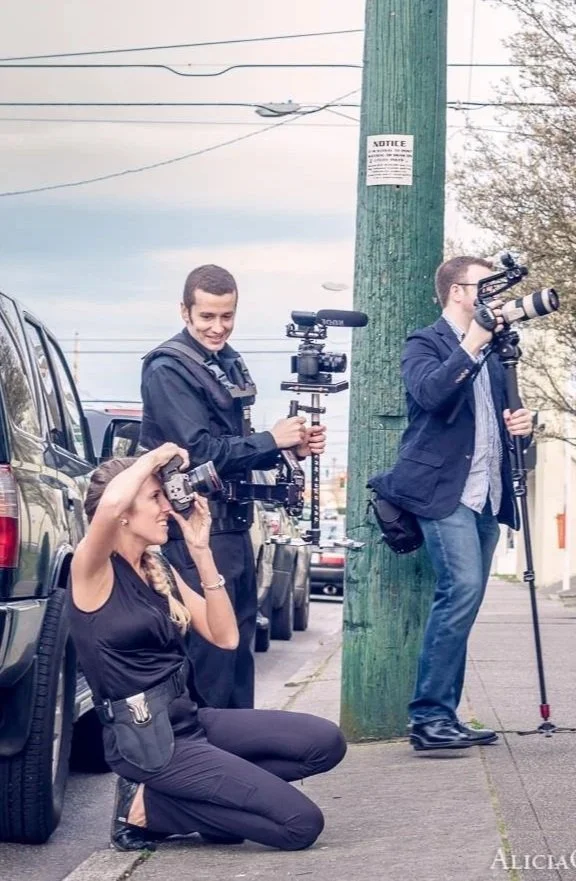 Alicia Maye on location during a professional photography shoot with videographers. Wedding and portrait photographer.