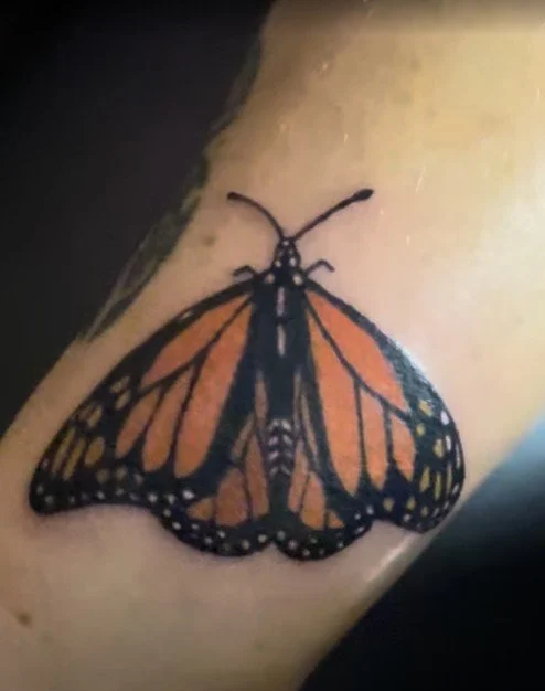 Monarch butterfly tattoo by Alicia Maye. Orange and black, color realism, Inklinations Cashmere WA.