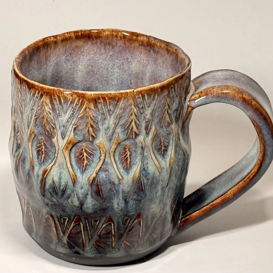 Hand-stamped stoneware mug by Alicia Maye. Nature-inspired glaze in earthy tones.
