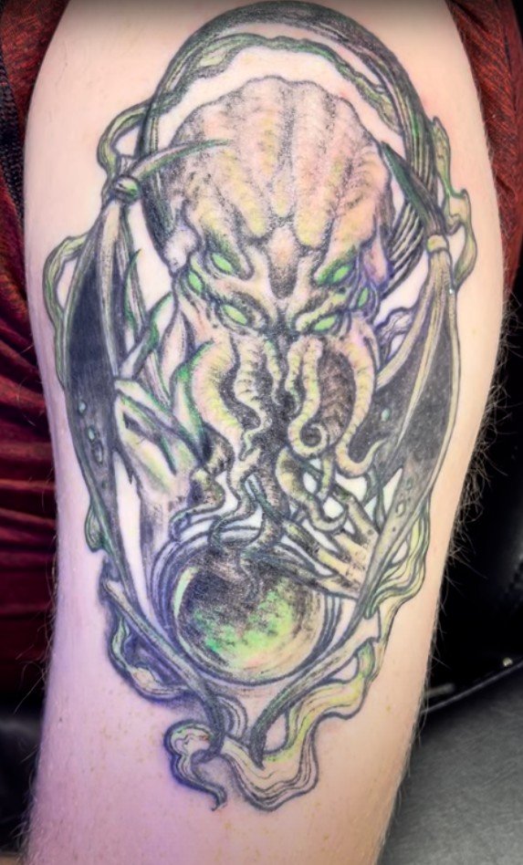 Custom illustrative tattoo cover up by Alicia Maye. Cthulhu design, detailed linework on arm.