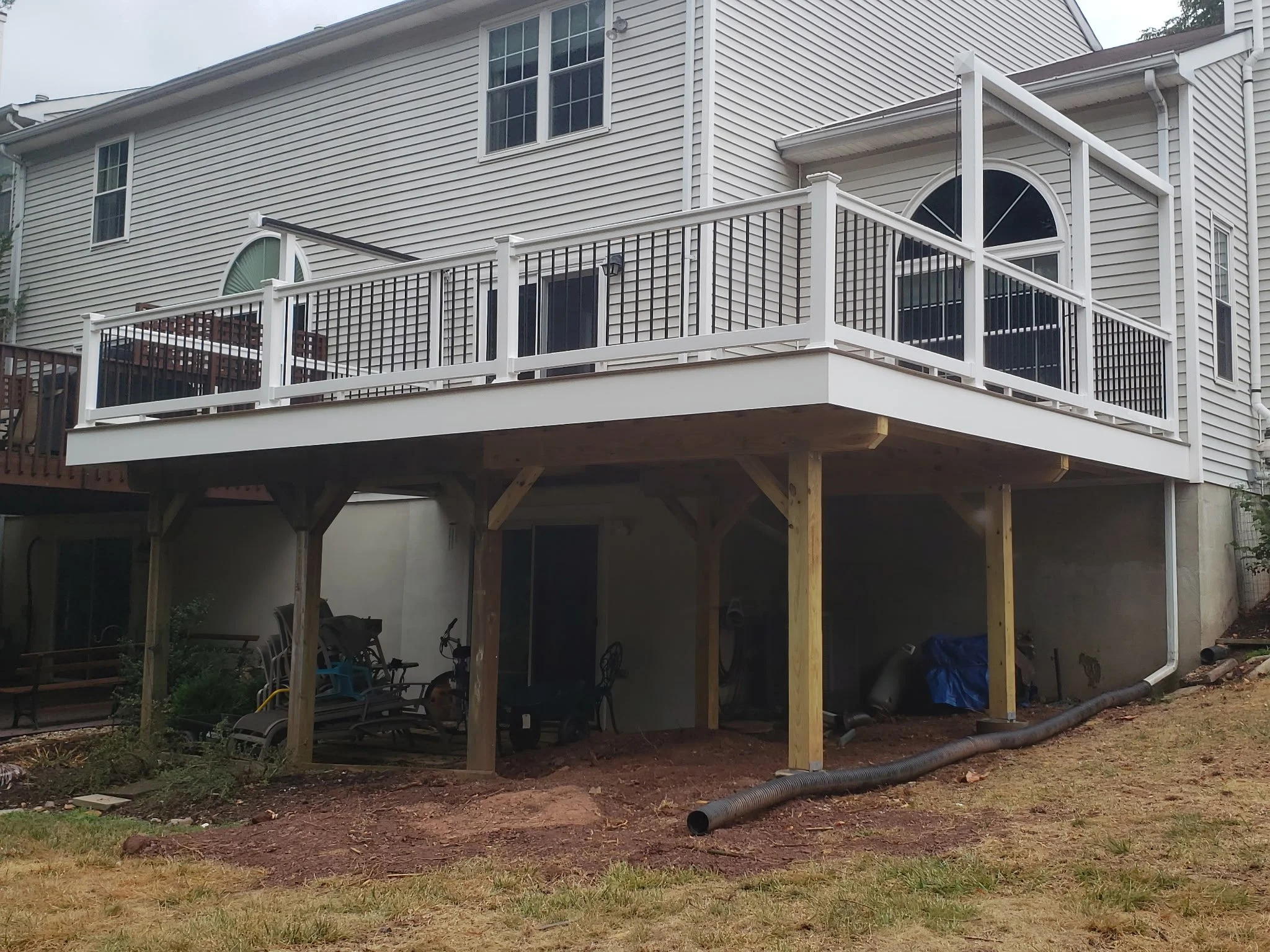 Deck with white Wolf Vinyl railings while showcasing the pressure treated structure underneath