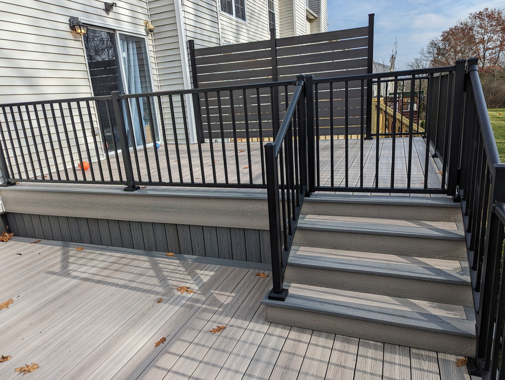 Westbury railings with Fiberon composite decking, and a custom privacy fence on the outer edge of the deck
