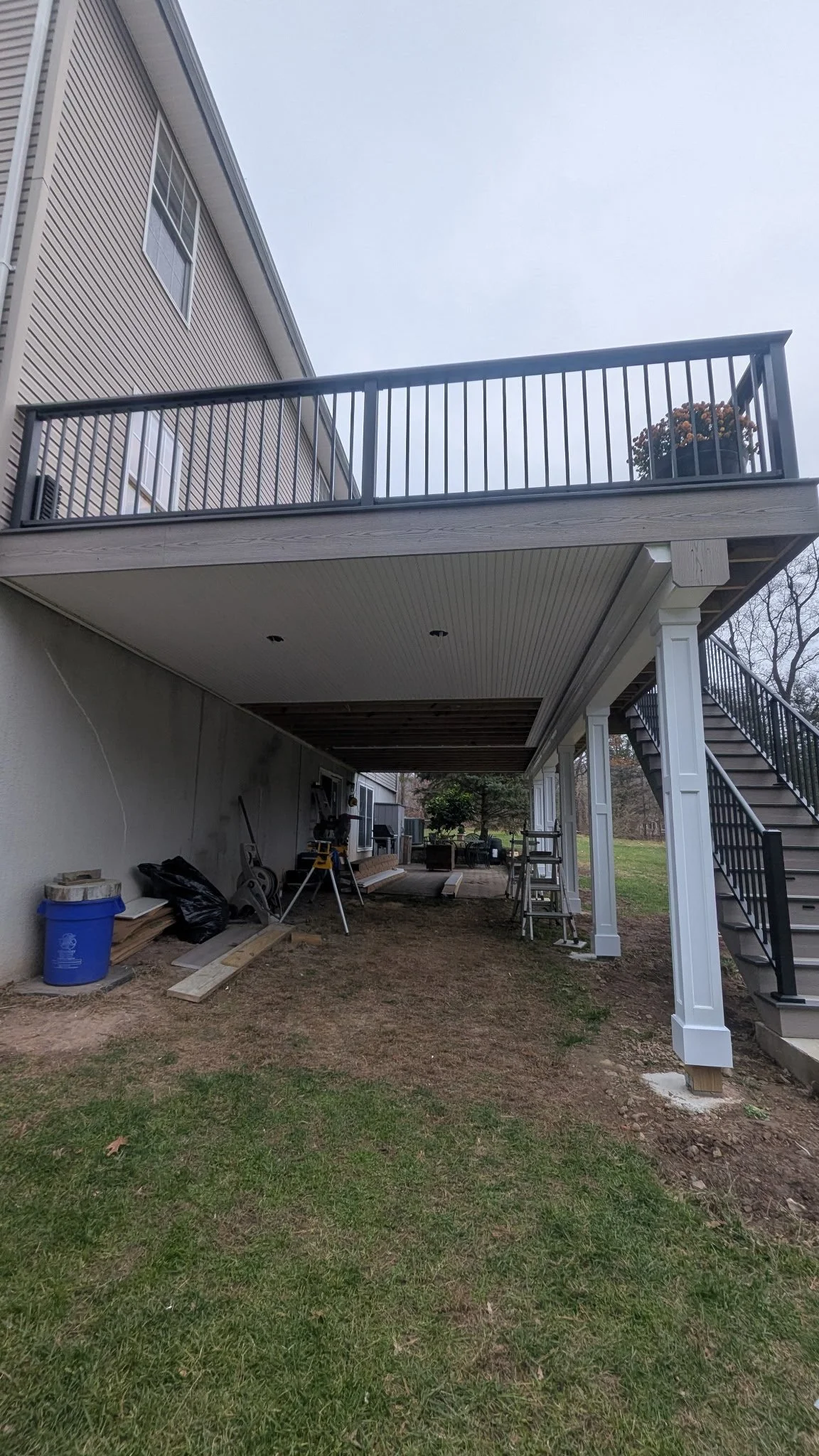 Showcasing work being done closing up the frame that has Trex RainEscape installed rainproofing the underside of the deck