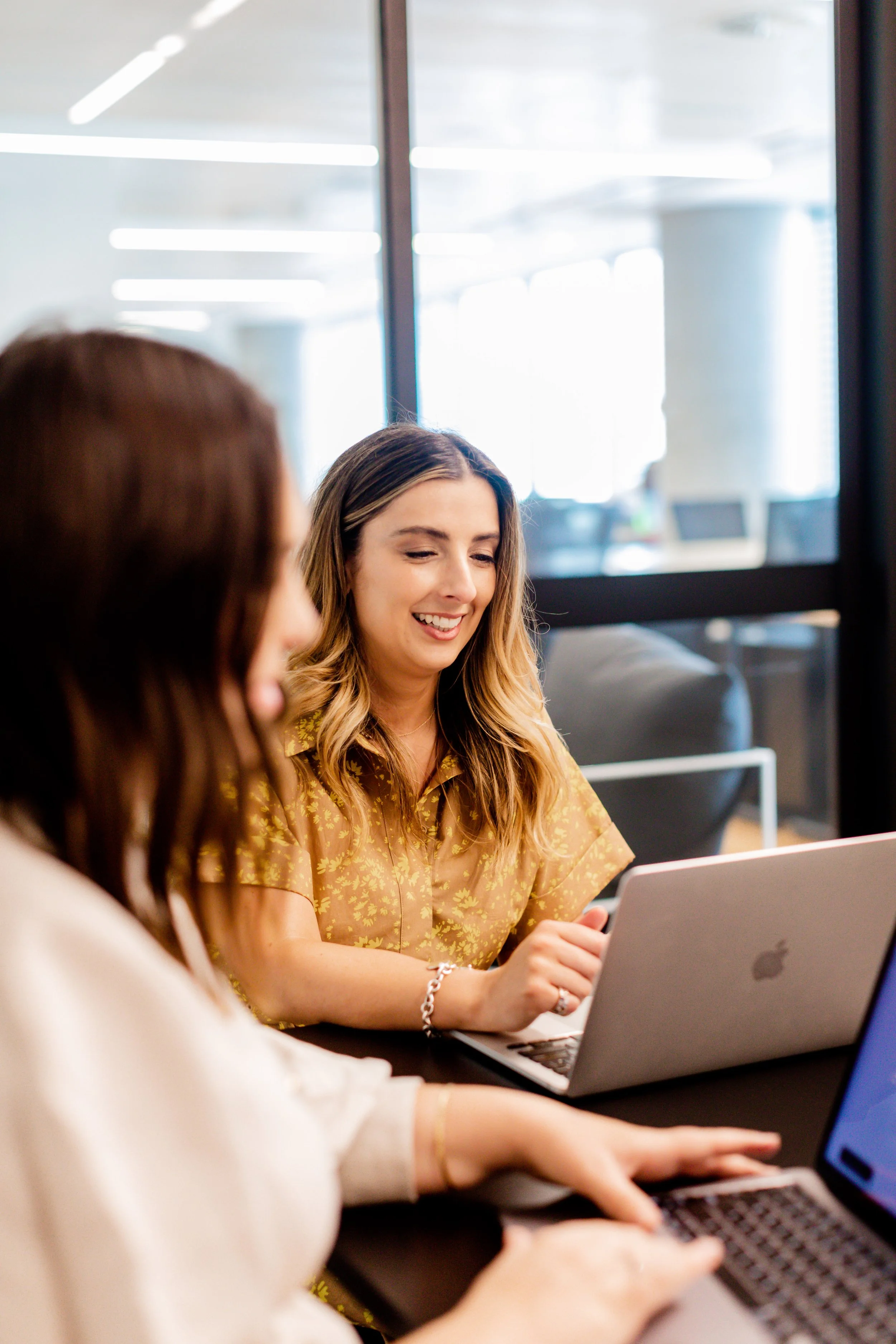 Ash and a People Co. team member working together on a laptop.