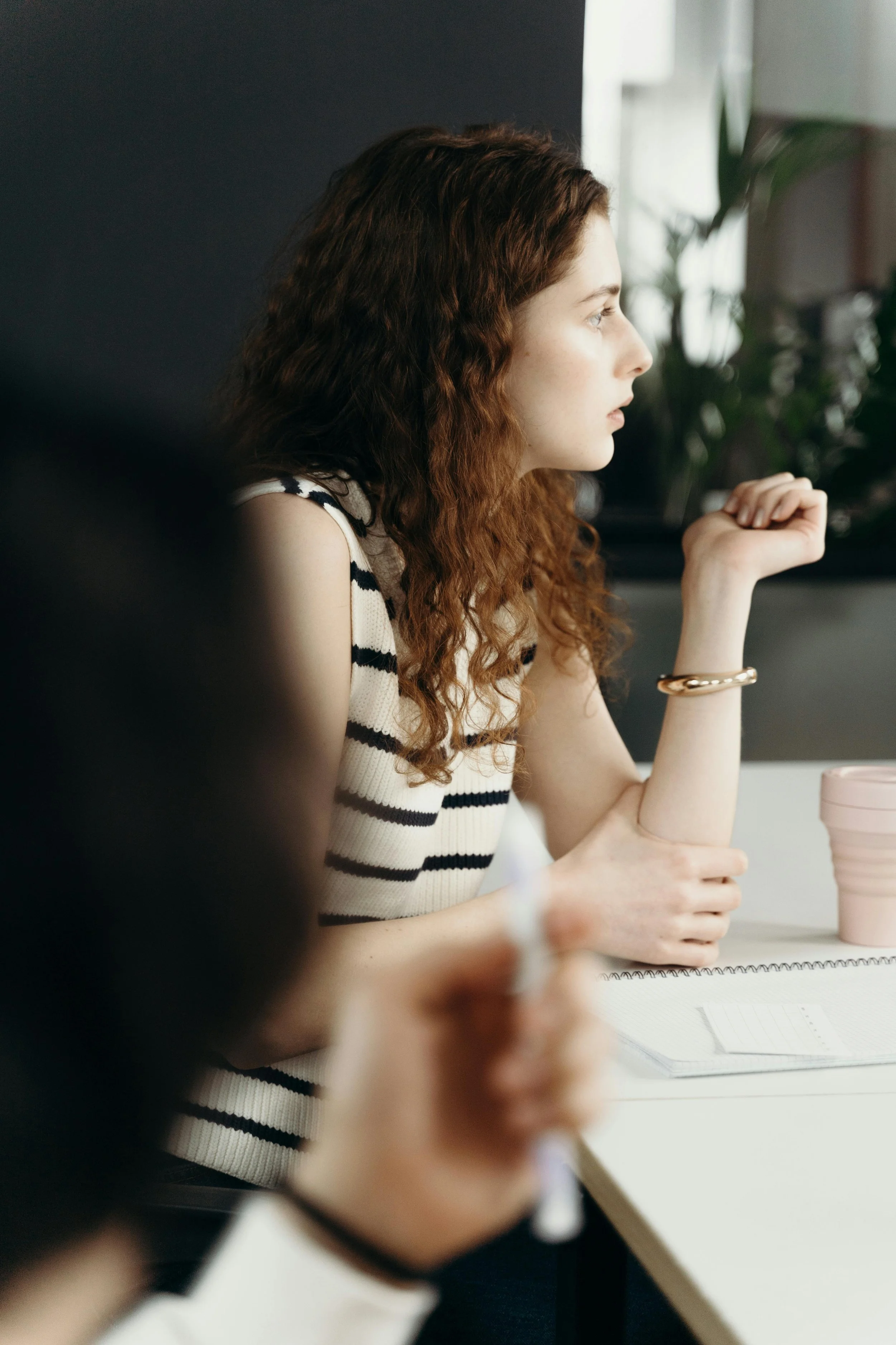 A team member listening closely during a workplace discussion.