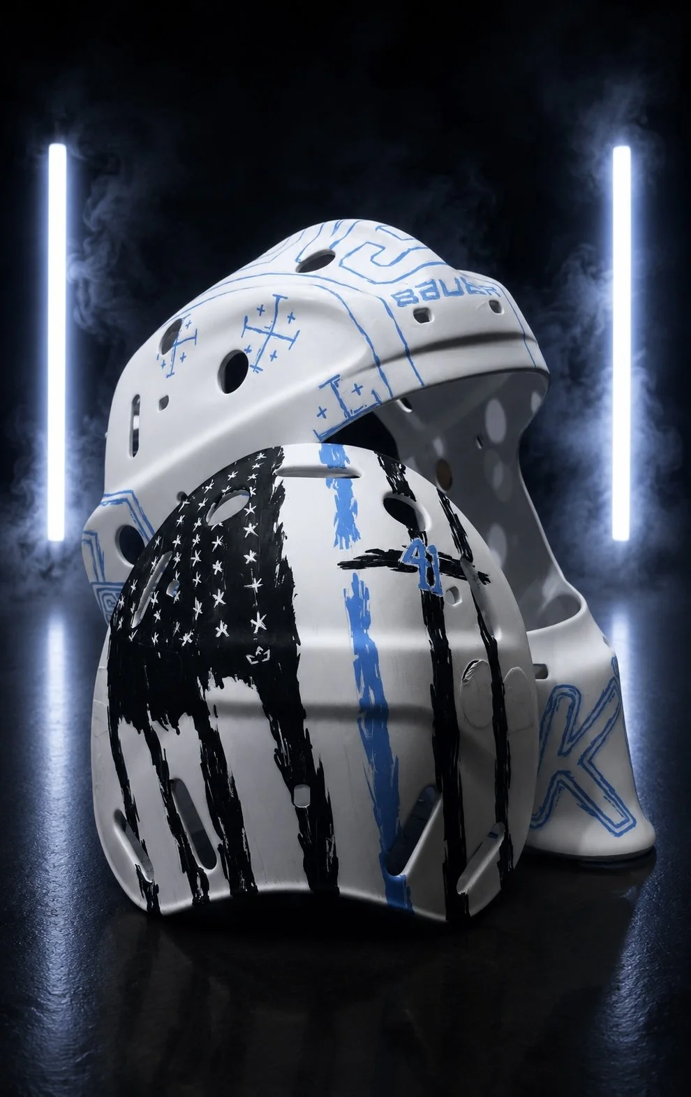 Two hockey helmets with graffiti-style art, set against a dark background with blue neon lights and smoke.