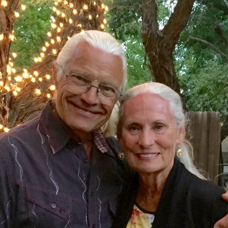 photo of david and linda hickman, under a tree with lights wrapped around the trunk