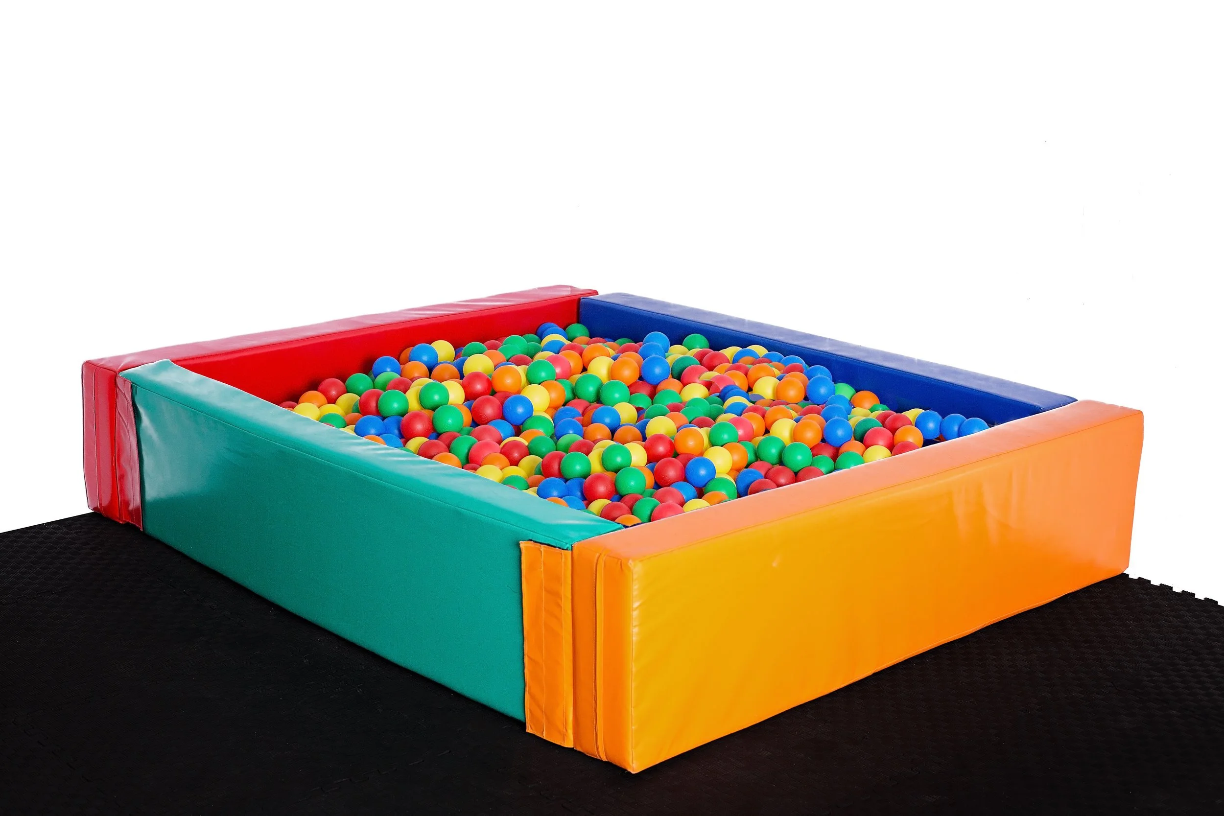 Colorful ball pit with red, blue, green, yellow, and orange plastic balls in padded, multicolored enclosure Toddler soft play ball pit hire Perth