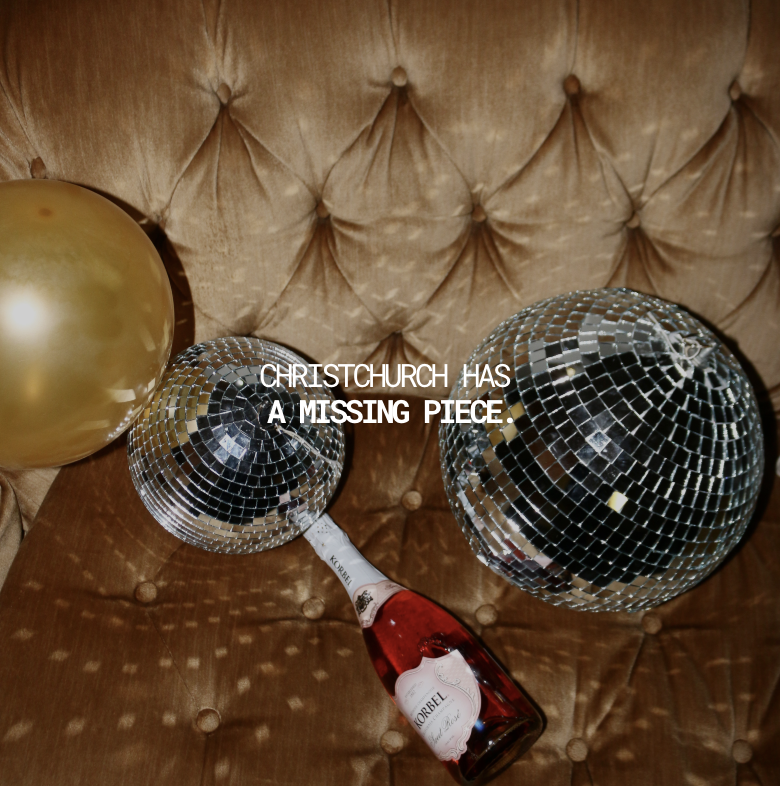Disco balls, a gold balloon, a bottle of Korbel champagne, and a missing piece sign on a tufted leather surface.