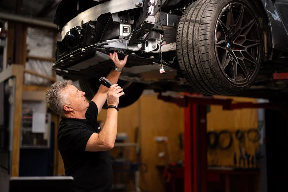 Repair certification inspection being carried out on a collision-damaged vehicle