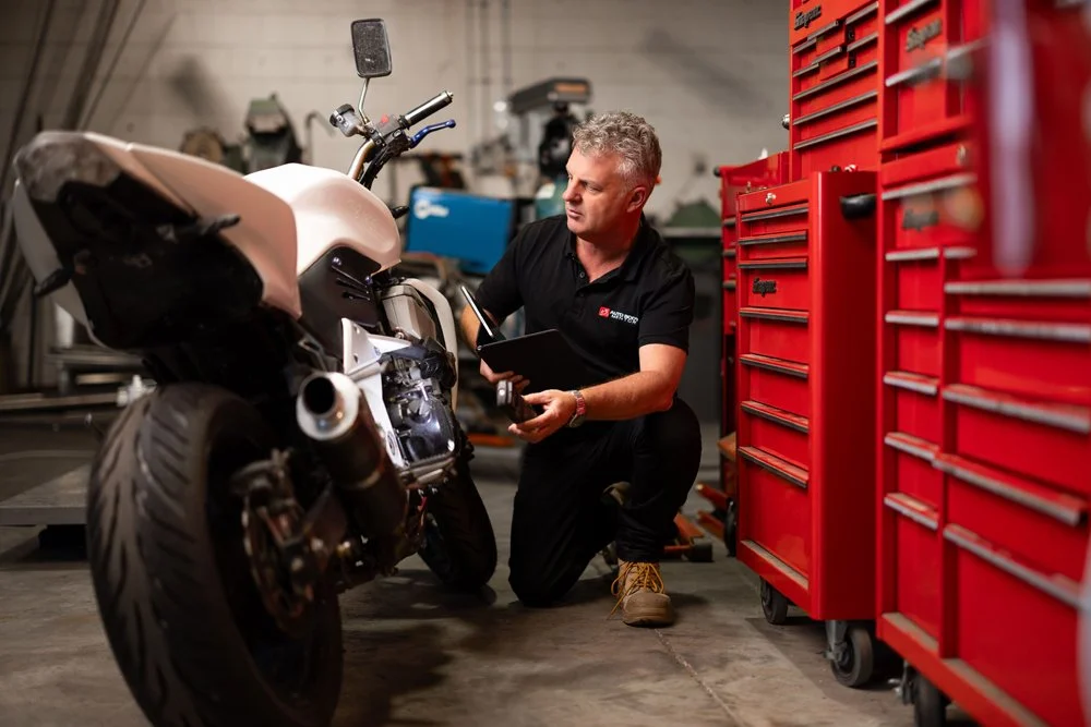 Andy Trumper discussing repair methods with automotive repair professionals