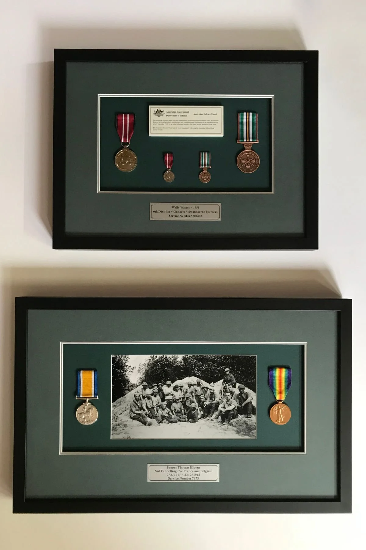 Military medal displays in black shadow box frames