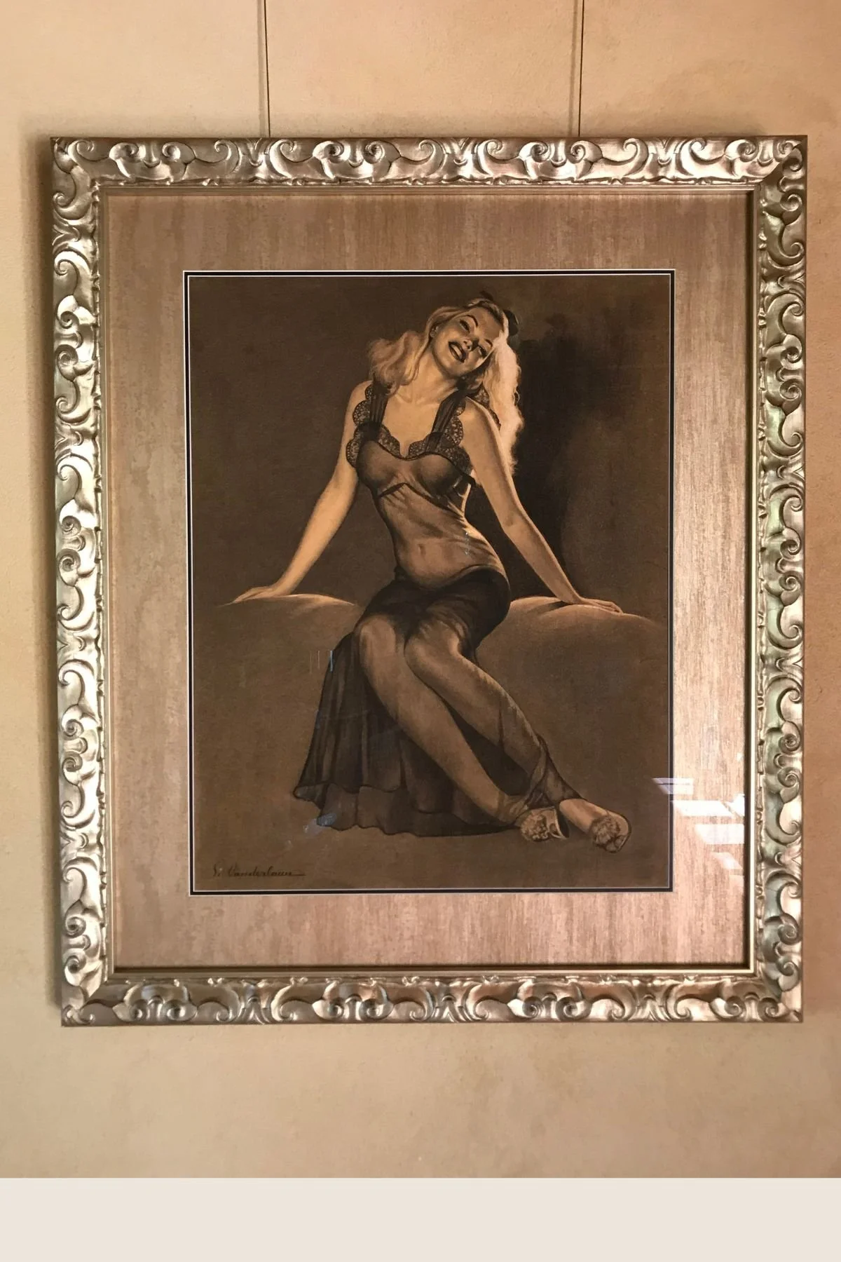 Vintage pin-up illustration in an ornate silver frame, linen mat
