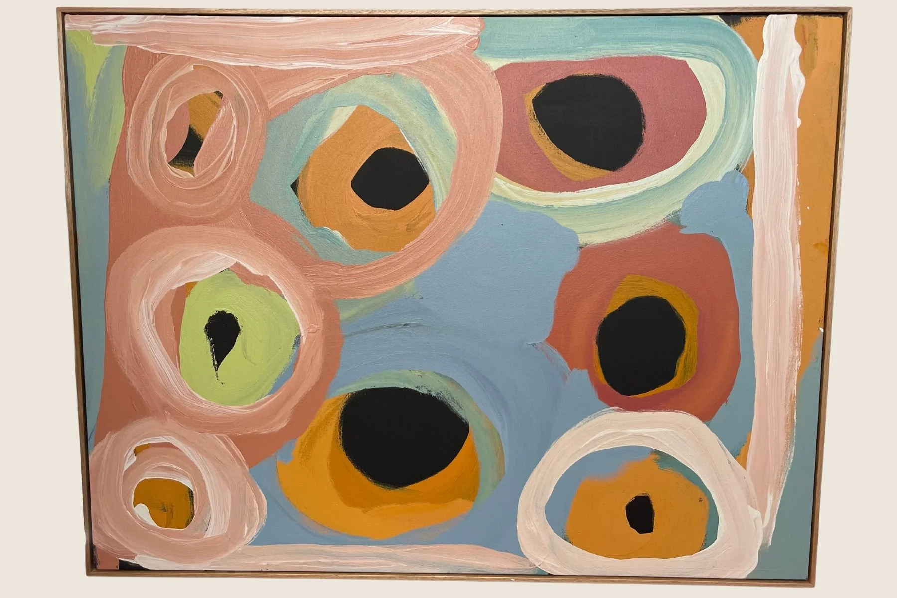 Abstract circle painting in a natural oak float frame
