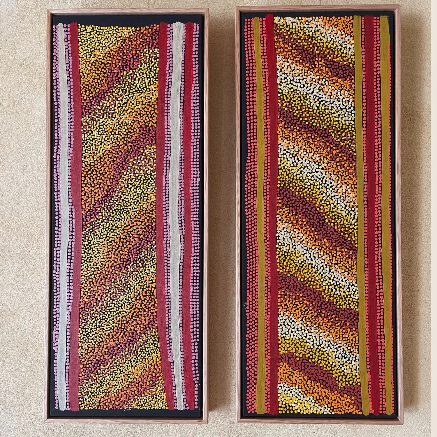 Matching pair of Aboriginal dot paintings in pink float frames