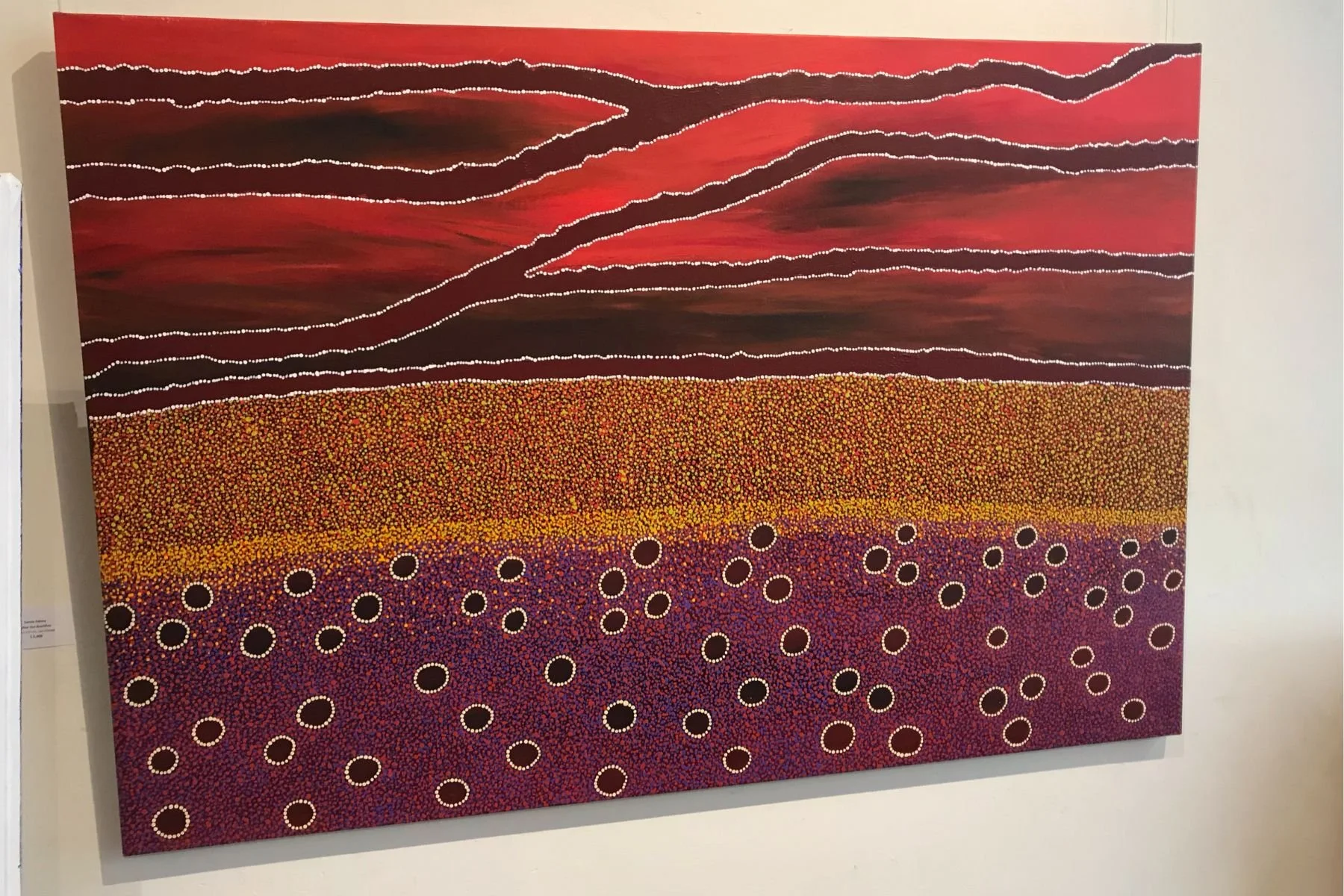 Aboriginal dot painting of a red desert landscape, stretched canvas